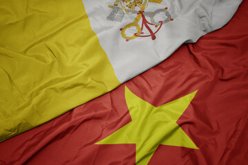 waving colorful flag of vietnam and national flag of vatican city.