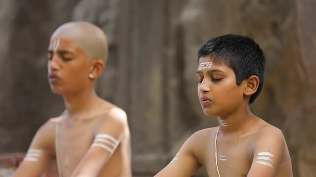 Young indian child  doing yoga in the park