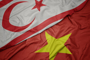 waving colorful flag of vietnam and national flag of northern cyprus.