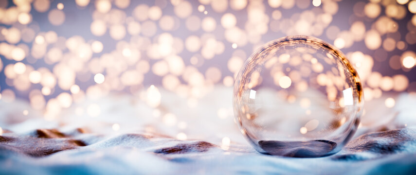Christmas glass ball on snow. Glitter lights