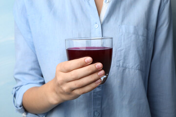Woman with glass of juice, closeup