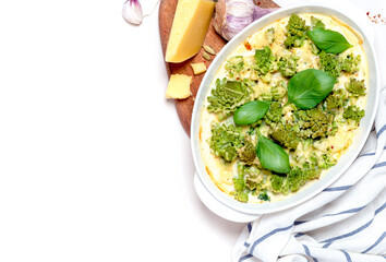 Baked Romanesco broccoli (Roman cauliflower) with cheese and creamy sauce in a baking dish on a white background. Top view.