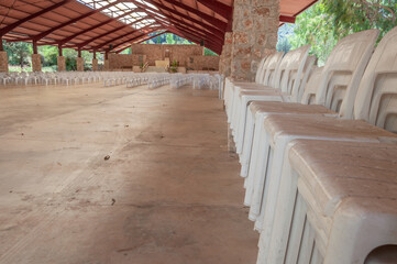 White plastic sallies stacked in a row inside a shed