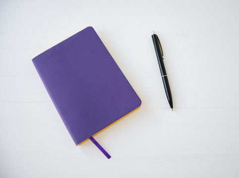 Top View Of Purple Notebook Cover With Pen.