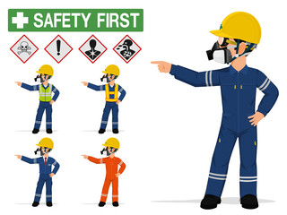 An industrial worker with respirator is pointing to something.