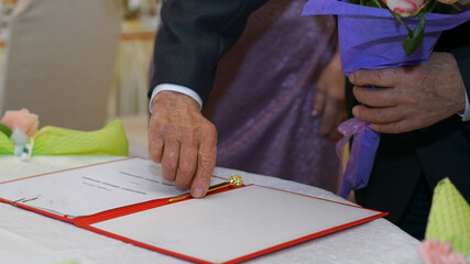 old elderly man hand make signature in marital conjugal