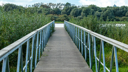 Fototapeta na wymiar wooden bridge leading to the river
