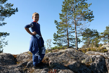 Kid on stone island in lake Ladoga skerries
