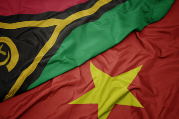 waving colorful flag of vietnam and national flag of Vanuatu .