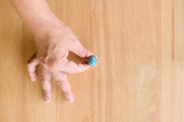 close up hand ring on wood table texture