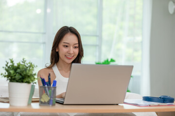 Beautiful Attractive Asian indian woman working with computer laptop and thinking to get ideas and requirement in Business startup at home feeling so happiness,Business Startup Concept