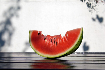 slice of watermelon on wooden table