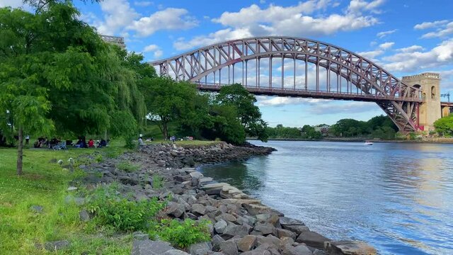 A Boat Speeding by the Hell Gate and JFK Bridge