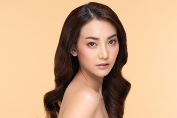 Naklejka premium Side view of Beautiful Asian woman smile with clean and fresh skin Happiness and cheerful with positive emotional,isolated on Beige background,Beauty and Cosmetics Concept