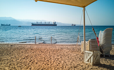 Sunny morning and safety swimming at sandy beach of the Red Sea, Middle East,