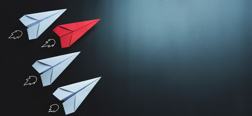 Leadership, red paper plane on black background, copy space