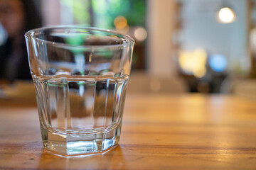 water in a glass with lime on table in cafe. Coffee break. Blurred image