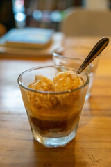 Cold Brew Iced Coffee Affogato, Vanilla Ice-Cream in a glass on wooden table background in Vietnamese coffee shop