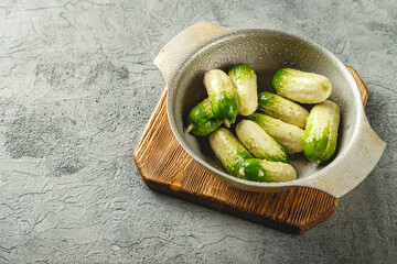 Baby cucumber on gray background