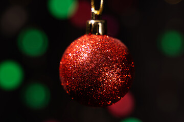 Fototapeta premium Red christmas ball on blur background.Bokeh background