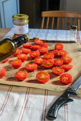Cherry Tomatoes sliced over a baking tray. 