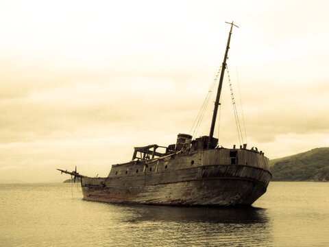 Old whaler on the sea background