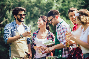 Friends having fun in nature doing bbq