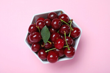 Sweet juicy cherries on pink background, top view