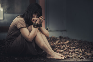Asian hostage woman Bound with rope at night scene,The thieves kidnapped for ransom,thailand people
