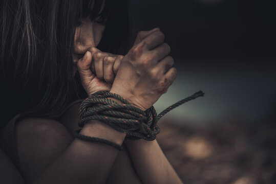 Asian hostage woman Bound with rope at night scene,The thieves kidnapped for ransom,thailand people