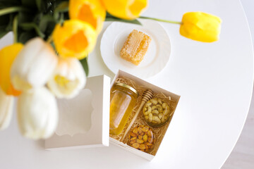 jars with nuts and honey, flowers