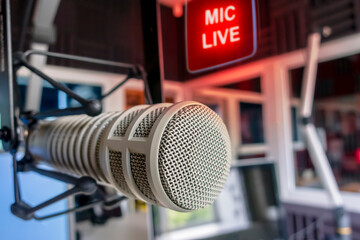Professional microphone in radio station studio and on air sign