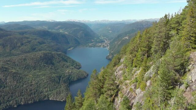 Small Norwegian Dalen town reveal behind highland mountains, aerial view