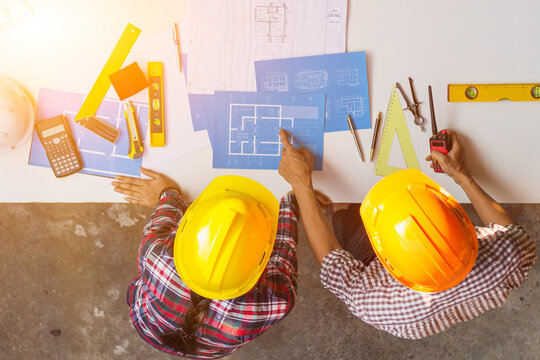 The engineer is giving advice and consulting with the designer to find out the construction site where the engineer will have to construct the project. Consultation between engineers and designers