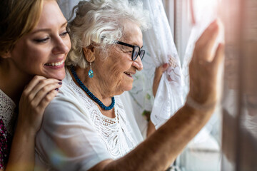 Young woman spending time with her elderly grandmother at home
