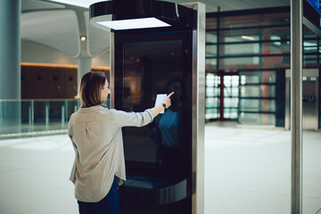 Anonymous woman using flight information screen