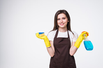 Young woman holding sponge and cleaning product on white background