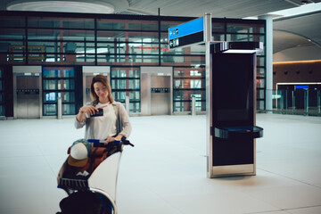 Obraz premium Young woman in eyeglasses with baggage in airport terminal