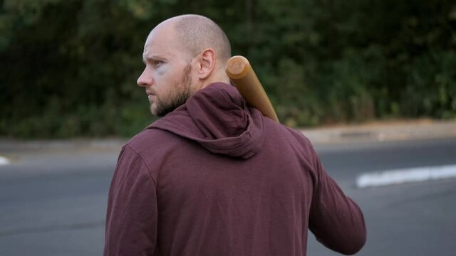 The bully hooligan looks around. Robber, bandit. Slow motion