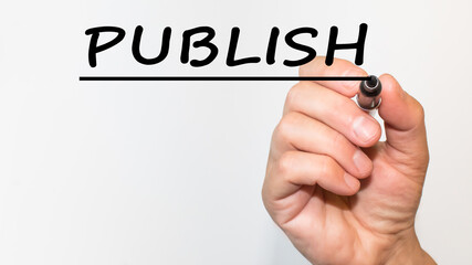 the hand writes the Word with a marker on a white background. business concept