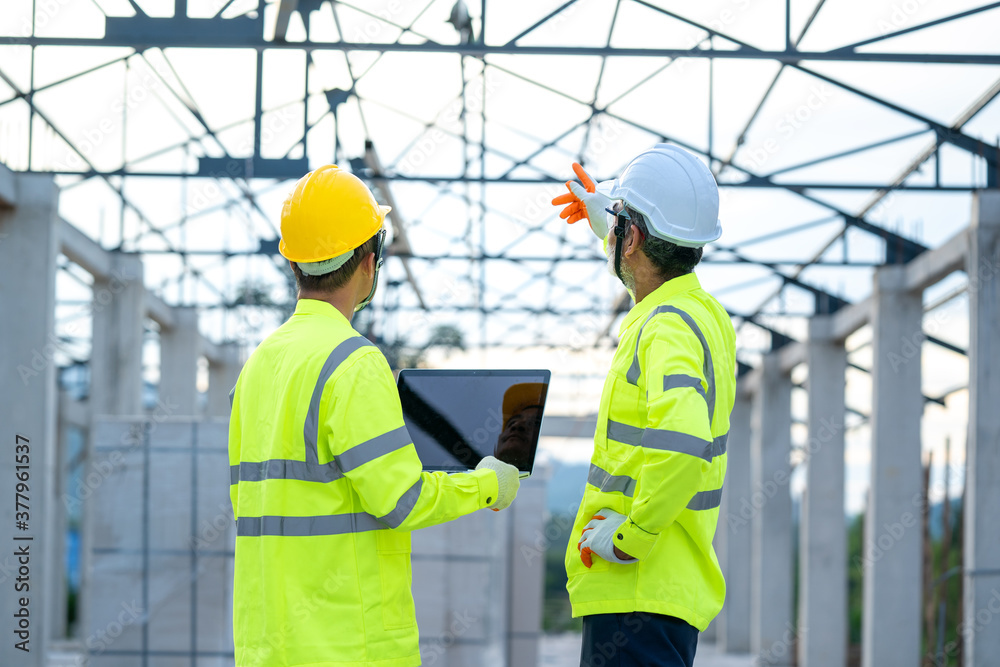 Aufkleber engineer using laptop working on building site,construction concept.