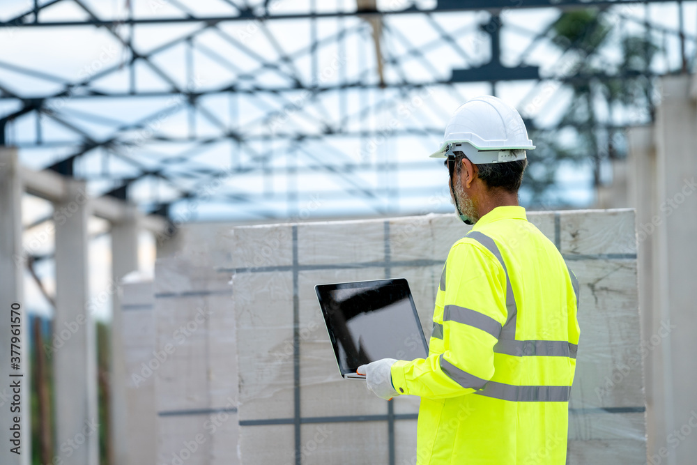 Aufkleber Engineer using laptop working on building site,Construction concept.