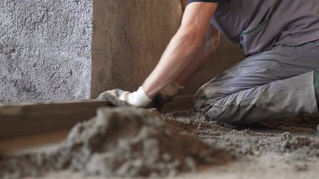 Plasterer Fresh Concrete Worker At Floor Leveling