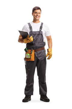 Full length portrait of a male worker with a tool belt holding a clipboard