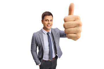 Professional young man showing thumbs up in front of the camera