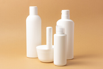 Set of white cosmetic bottles and jars with place to add text