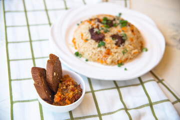 .pilaf and salad, black bread on the table
