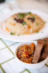 .pilaf and salad, black bread on the table