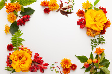 Autumn composition with flowers, leaves and berries on white background. Flat lay, copy space.
