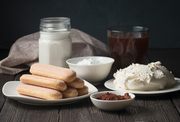 Ingredients for tiramisu cake, cookies, cream, mascarpone, powdered sugar, cocoa and coffee.
